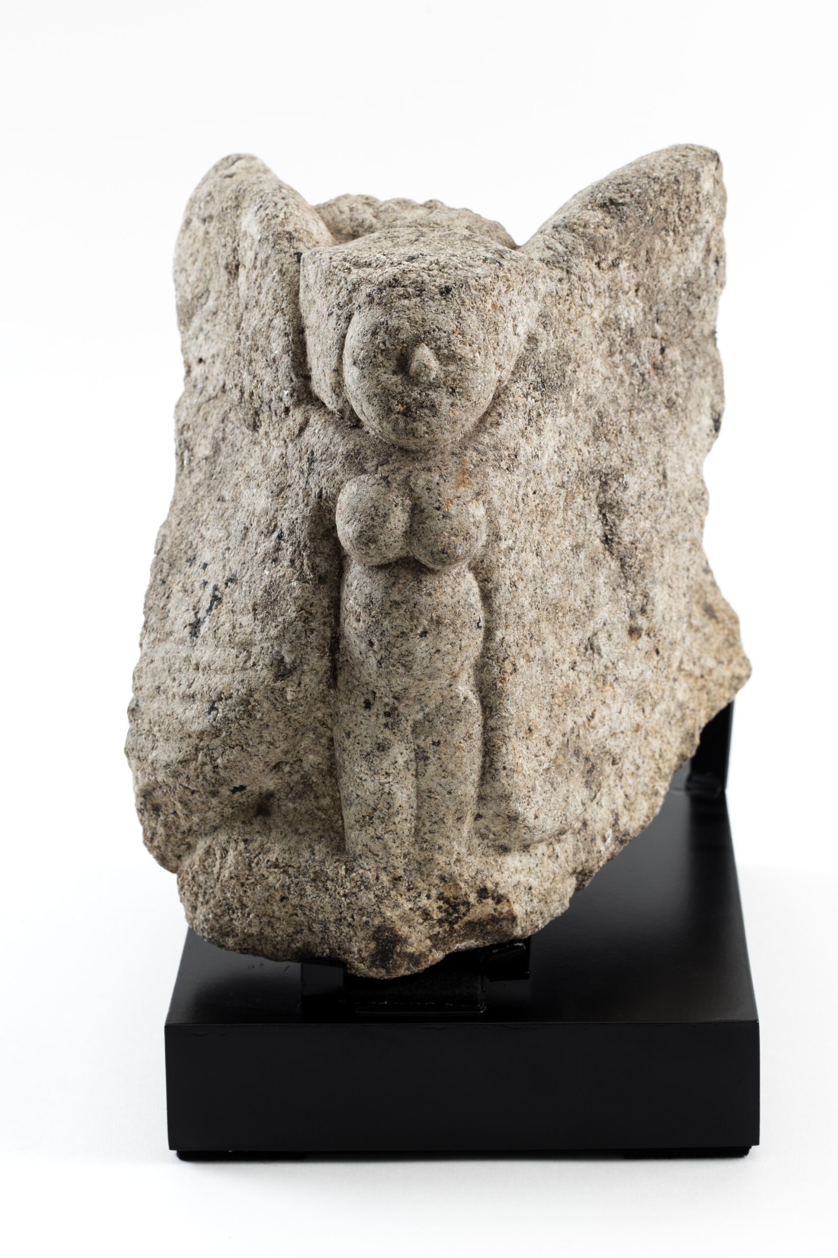 Carved stone capital representing the body of a woman with wings